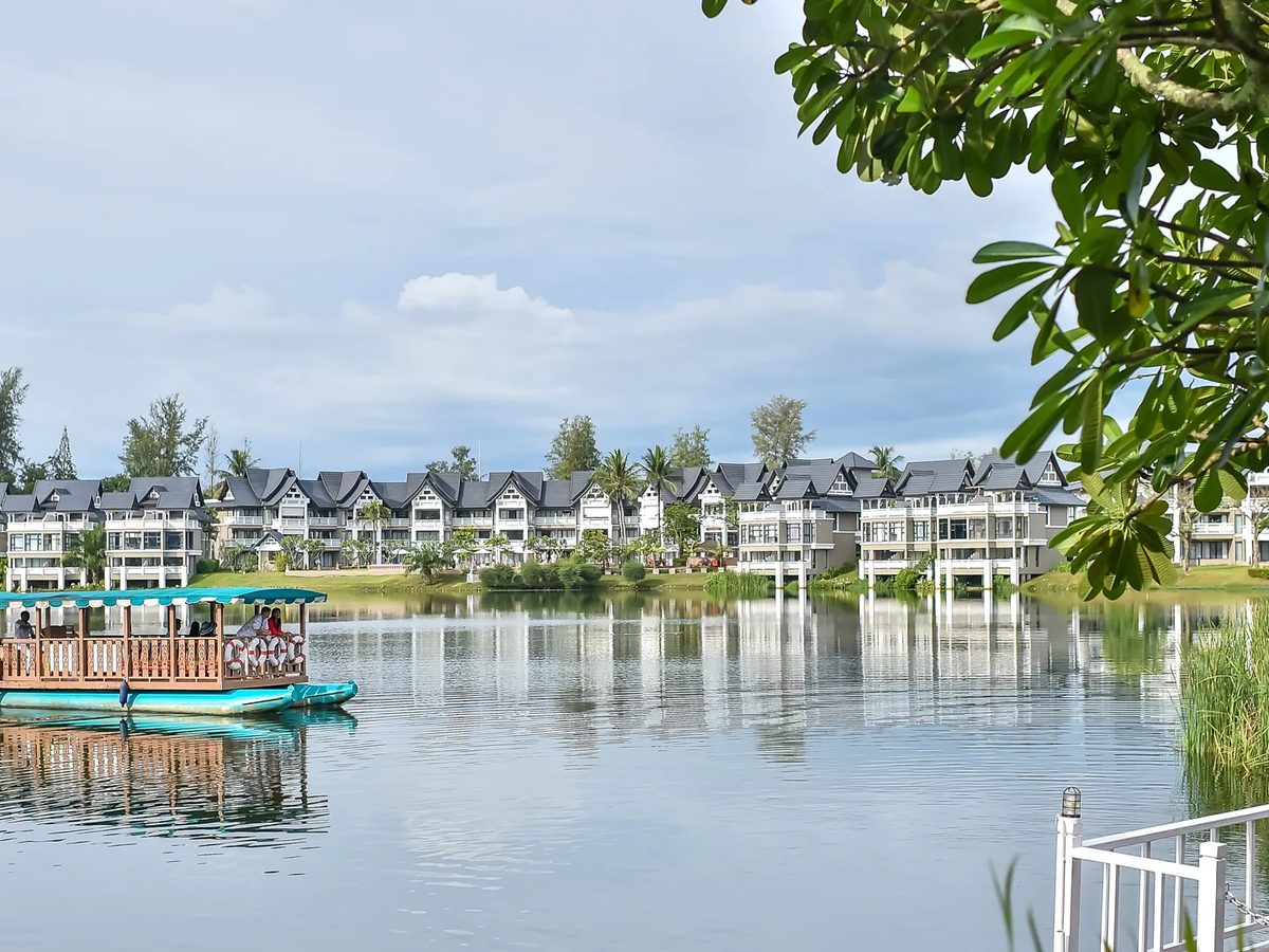 Traditional shuttle boat crossing the Laguna Phuket lagoon