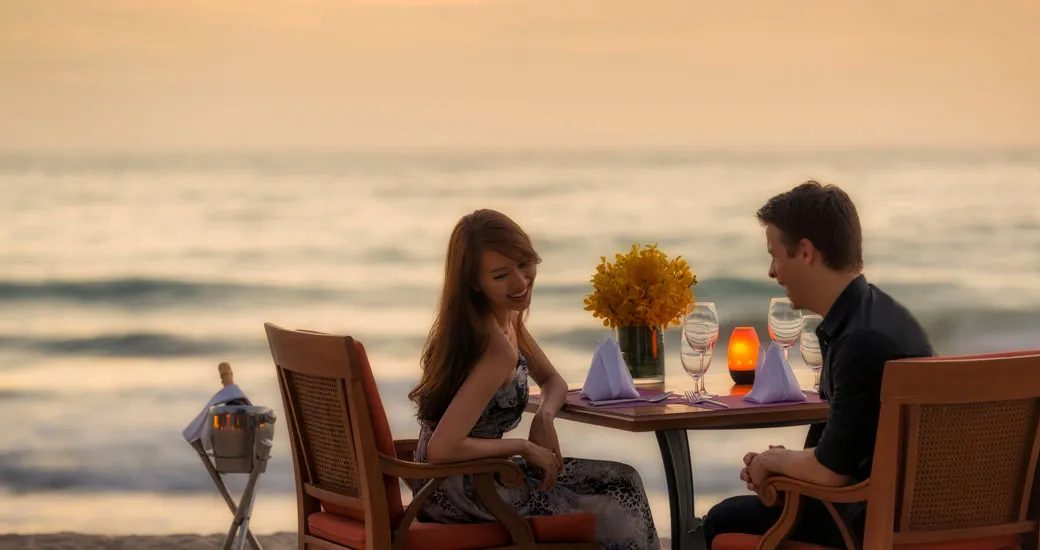 Beachfront dining at sunset near Laguna Phuket